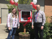 Cape Horn-Skye Elementary School teacher Darcy Hickey (left) and principal Brian Amundson attended a ribbon-cutting ceremony to celebrate the debut of the school's new little free library on May 1.