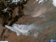 Wildfire smoke blows eastward from the mountains of New Mexico as a sandstorm sweeps down from eastern Colorado in this April 29, 2022, NOAA satellite image.