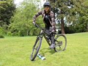 Emily Ford, a coach and instructor with Radical Roots MTB in Bellingham, Washington, demonstrates a practice technique for steering around trail obstacles.