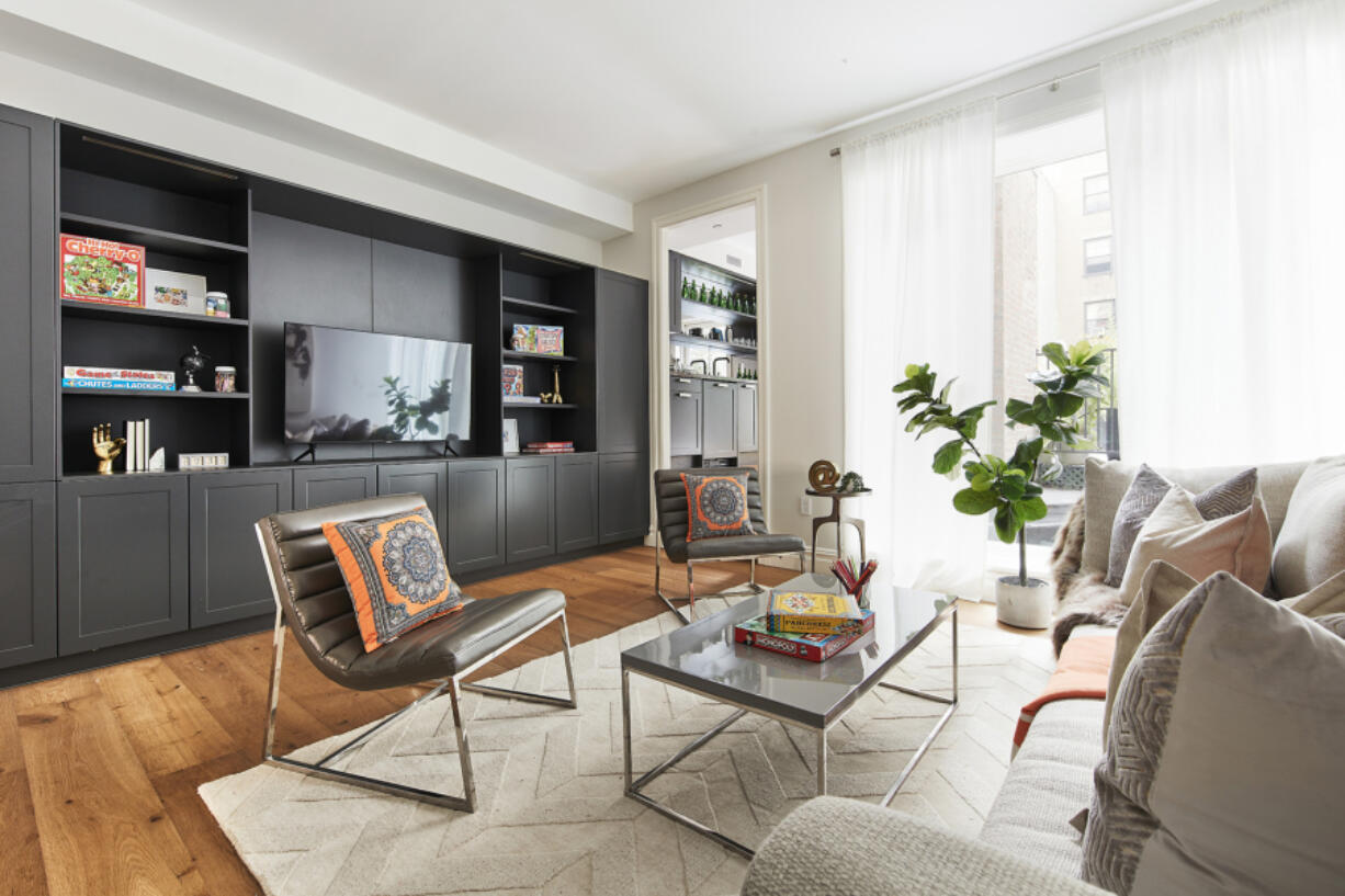 A family room includes a wall of elegant built-ins.