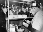 Hot dogs were popular at ball games and here, a hot dog vendor sells to fans at Wrigley Field during a game on April 14, 1970.