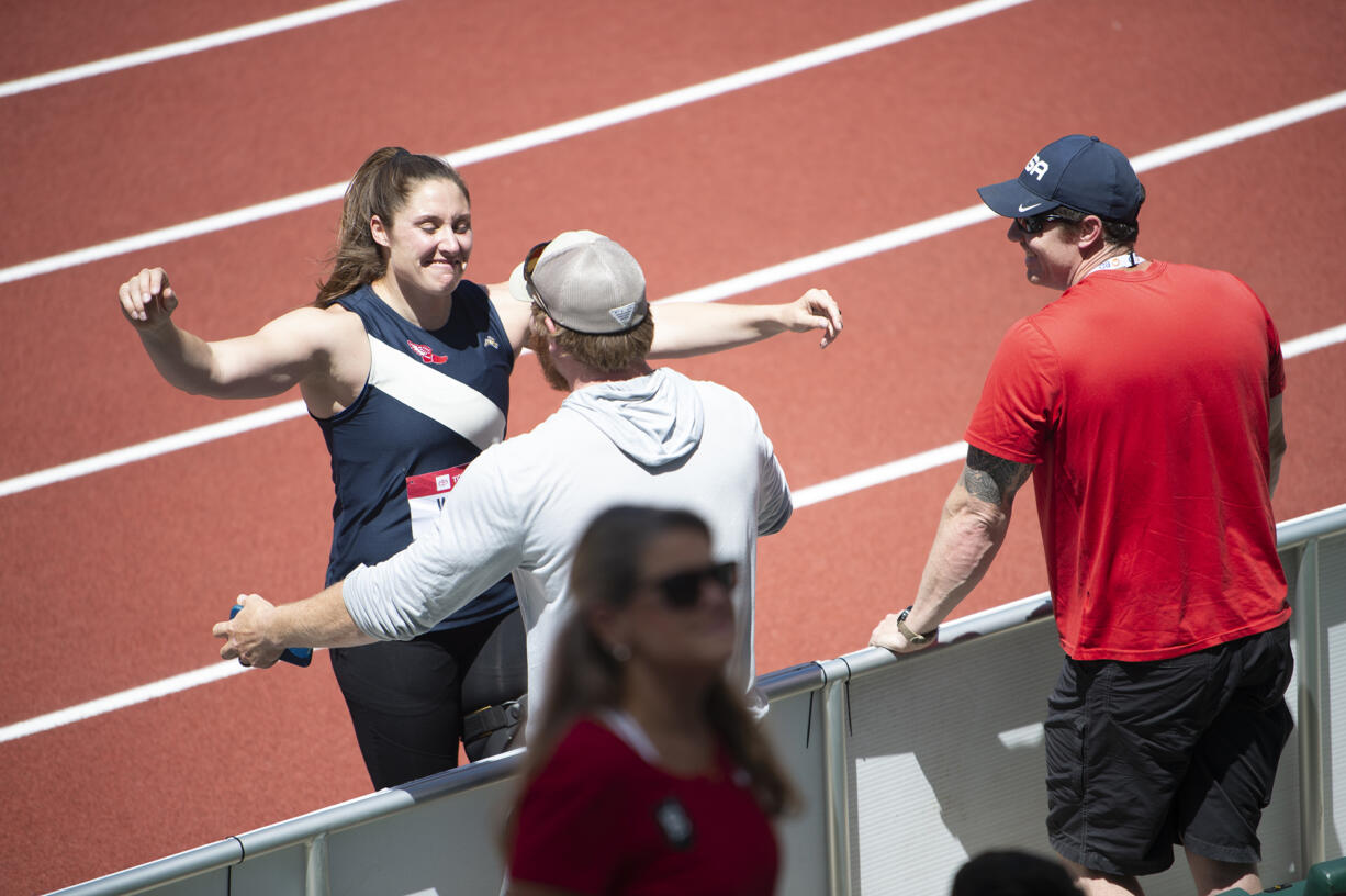 Kara Winger hugs her husband and coach Russ Winger after winning the women's javelin at the U.S. outdoor track and field championships on Saturday, June 25, 2022, in Eugene, Ore.