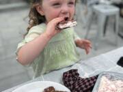 Greta McKay, 2, enjoys a homemade ice cream sandwich filled with no-churn strawberry ice cream.