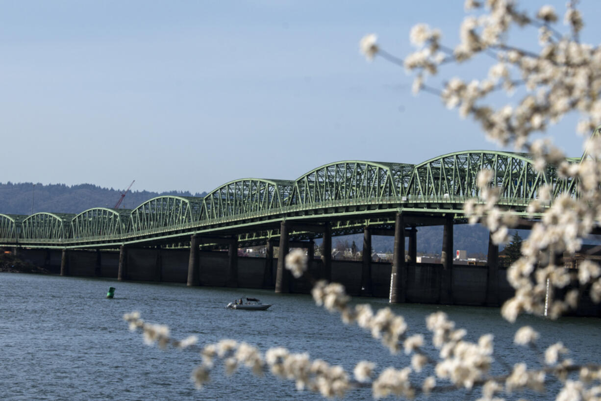 Delicate blossoms frame the Interstate 5 Bridge as they brighten the Vancouver Waterfront on March 24. The Interstate Bridge Replacement Program's locally preferred alternative is making rounds to local agencies before it can progress to the next project phase.