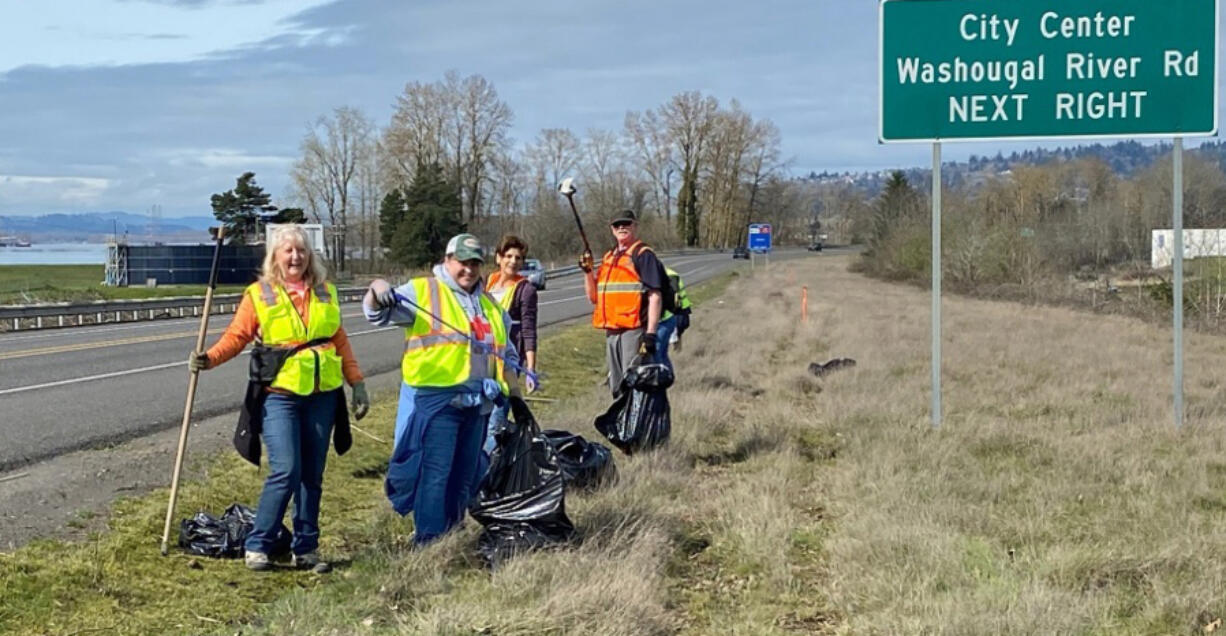 From left: Camas and Washougal residents Brenda Hatton, Lynne Lyne, Wendi Moose and John Meier pose for a photograph while picking up trash alongside state Highway 14 on March 23.