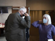 Mike Westby, CEO of Westby Associates, left, shares an elbow bump with U.S. Sen. Patty Murray as she tours Family Solutions, a Vancouver mental health agency, on Wednesday morning.