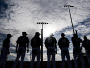 Partly cloudy skies hang above Ridgefield Raptors players Wednesday, June 1, 2022, during introductions before an exhibition game between the Ridgefield Raptors and the Cowlitz Black Bears at the Ridgefield Outdoor Recreation Complex.