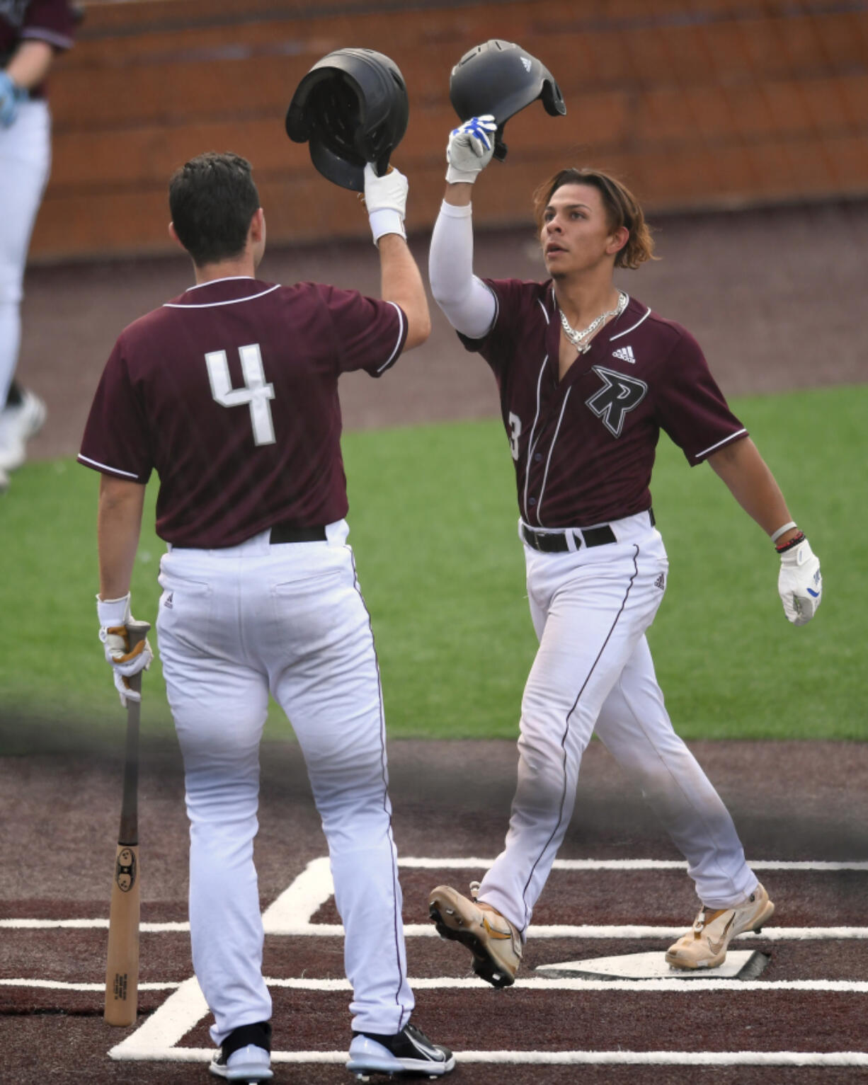 Ridgefield Raptors' Jacob Sharp, right, celebrates with teammate Doyle Kane after Sharp hit a home run during an exhibition game Wednesday against the Cowlitz Black Bears at the Ridgefield Outdoor Recreation Complex. The Raptors' regular season opens Friday at home against Walla Walla.