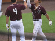 Ridgefield Raptors' Jacob Sharp, right, celebrates with teammate Doyle Kane after Sharp hit a home run during an exhibition game Wednesday against the Cowlitz Black Bears at the Ridgefield Outdoor Recreation Complex. The Raptors' regular season opens Friday at home against Walla Walla.