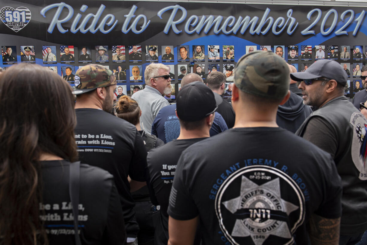 JC Shah, founder of Beyond the Call of Duty, right, joins law enforcement officers and family members of slain Clark County sheriff's Sgt. Jeremy Brown on Thursday as they honor his memory at The Gathering Place church in Hazel Dell. The End of Watch Ride to Remember is a group of motorcyclists who escort a 40-foot trailer across the country to honor fallen officers from the prior year.