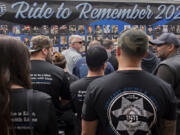 JC Shah, founder of Beyond the Call of Duty, right, joins law enforcement officers and family members of slain Clark County sheriff's Sgt. Jeremy Brown on Thursday as they honor his memory at The Gathering Place church in Hazel Dell. The End of Watch Ride to Remember is a group of motorcyclists who escort a 40-foot trailer across the country to honor fallen officers from the prior year.