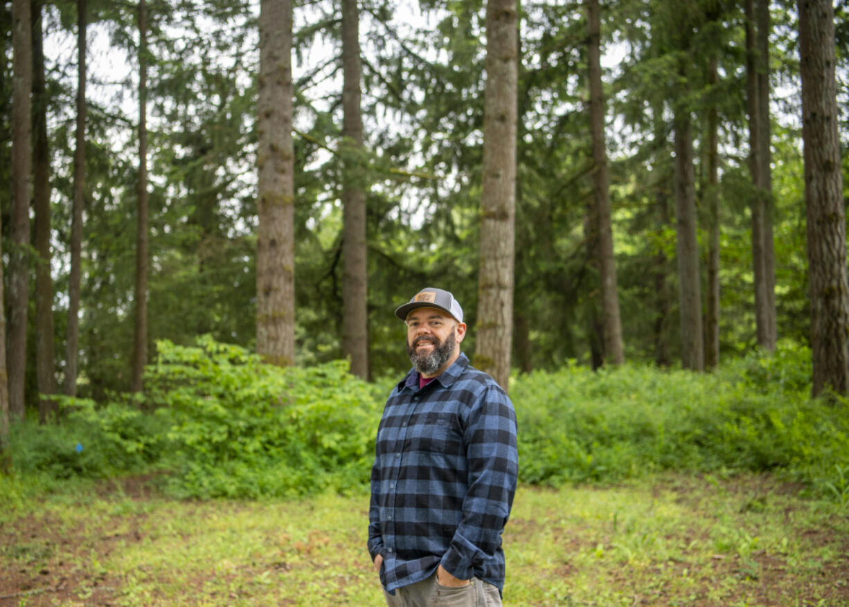 Gather and Feast Farm owner Mark Lopez stands on his property  in La Center. Farmers seeking to use their property to host weddings are facing an uncertain future. Lopez is standing in what he calls the "Cathedral of Trees" on his farm.