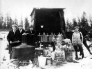 Standing amid confiscated liquor in this 1927 photo, Sheriff Lester Wood, third from left, and five men examine the haul. Wood was one of four law officers who died from gunshot wounds enforcing prohibition laws forced on them by the 18th Amendment.