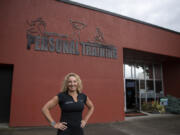 Sherri McMillan, owner of Northwest Personal Training, takes a break in downtown Vancouver on Monday afternoon. She was able to use a Small Business Administration loan program to purchase the building she's been leasing for 22 years.