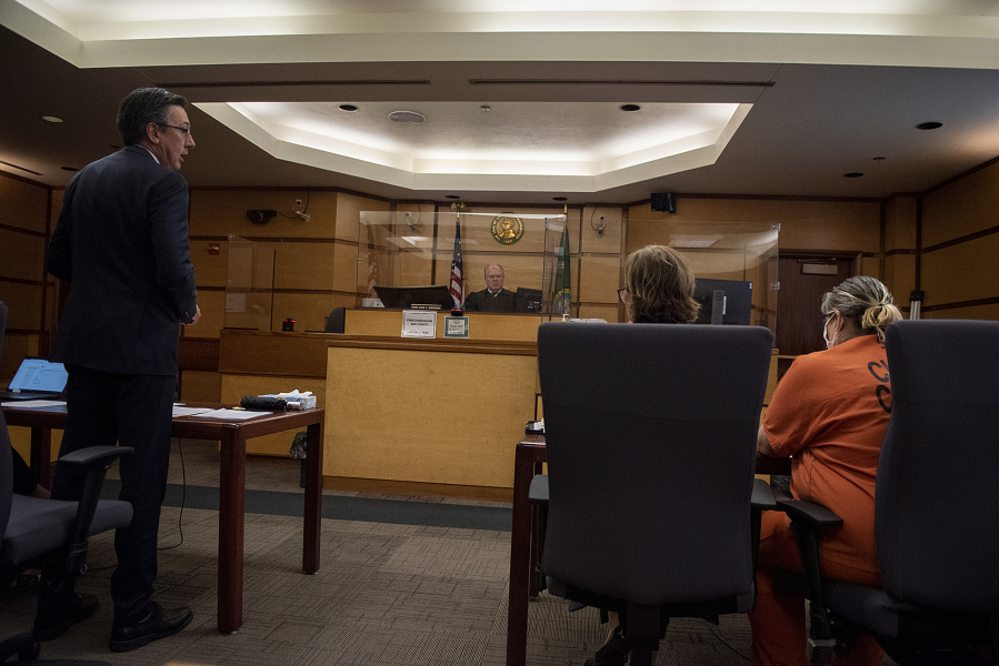 Clark County Prosecutor Tony Golik, left, speaks as Lani Kraabell, right, sits in the courtroom while pleading guilty to second-degree manslaughter June 10 in connection with sheriff's Sgt. Jeremy Brown's shooting.