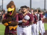 Rally the Raptor, left, and Ridgefield Raptors players stand for the national anthem Tuesday, June 14, 2022, during a Raptors game against the Edmonton Riverhawks at the Ridgefield Outdoor Recreation Complex.