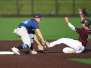 Raptors' Trent Prokes, right, is tagged out by Edmonton shortstop Kelly Corl on Tuesday, June 14, 2022, during a Raptors game against the Edmonton Riverhawks at the Ridgefield Outdoor Recreation Complex.