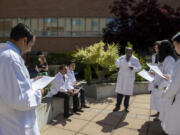 Dr. Ozone Gautam, left, looks over his bio while joining fellow members of a new Internal Medicine Residency Program at Legacy Salmon Creek Medical Center. "Everyone has been so welcoming, inside and outside of the hospital," Gautam said. "I'm settling in well.