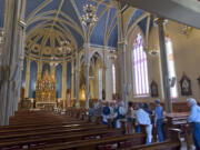 Members of the Angora Hiking Club attend a sacred art tour of the Proto Cathedral of St. James the Greater in Vancouver on Saturday. At top is the exterior of the cathedral, which was built in 1885.