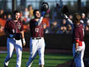 Raptors left fielder Alex Sepulveda, center, celebrates with third baseman Travis Welker, right, after Sepulveda hit a two-run home run Friday, June 24, 2022, during a game between Ridgefield and the Victoria HarbourCats at the Ridgefield Outdoor Recreation Complex.