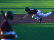 Raptors center fielder Austin Caviness dives for third base Friday, June 24, 2022, during a game between Ridgefield and the Victoria HarbourCats at the Ridgefield Outdoor Recreation Complex.