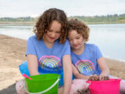 Bailey Wilkes, left, and her younger sister Sammy play in the sand at Vancouver Lake. At 6 months old, Bailey was diagnosed with severe allergies to more then 20 different kinds of food, including eggs and most kinds of nuts. Now, thanks to a unique program at the Southern California Food Allergy Institute and a grant provided by United Healthcare Children's Foundation, Bailey is on her way to overcoming many of her allergies.