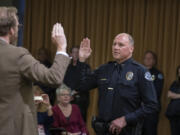 Vancouver City Attorney Jonathan Young, left, swears in Jeffrey Mori as the new chief of the Vancouver Police Department on June 30, 2022, at Vancouver City Hall. Mori previously served as an assistant chief at the agency for three years.