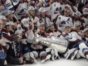 The Colorado Avalanche pose with the Stanley Cup after defeating the Tampa Bay Lightning 2-1 in Game 6 of the NHL hockey Stanley Cup Finals on Sunday, June 26, 2022, in Tampa, Fla.