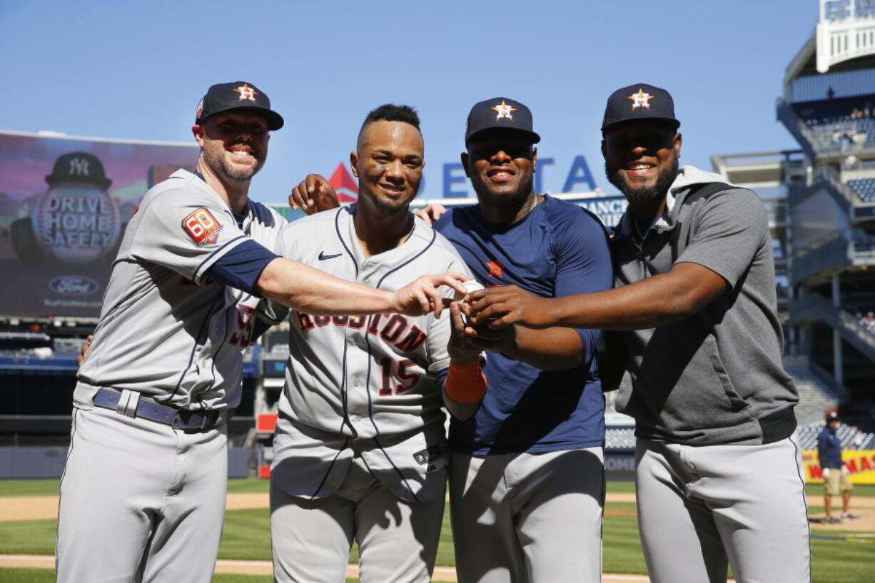 Houston Astros players, from left, relief pitcher Ryan Pressly, catcher Martin Maldonado, relief pitcher Hector Neris, and starting pitcher Cristian Javier celebrate after a combined no-hitter against the New York Yankees. Saturday, June 25, 2022, in New York. The Houston Astros won 3-0. (AP Photo/Noah K.