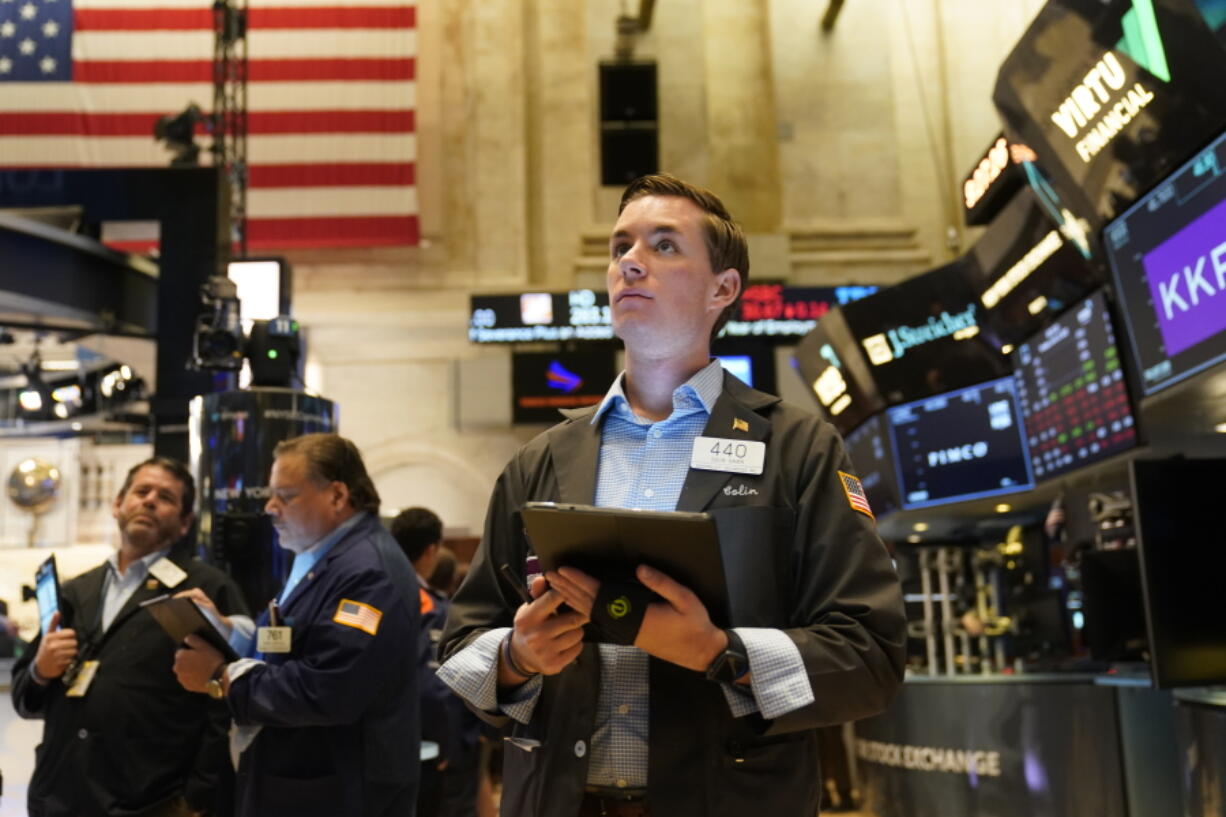 Traders work on the floor at the New York Stock Exchange in New York, Tuesday, June 14, 2022. Wall Street is wobbling between gains and losses Tuesday in its first trading after tumbling into a bear market on worries about a fragile economy and rising rates.