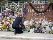 Reggie Daniels pays his respects a memorial at Robb Elementary School, Thursday, June 9, 2022, in Uvalde, Texas, created to honor the victims killed in the recent school shooting. Two teachers and 19 students were killed in the mass shooting.