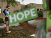 Planned Parenthood advocacy programs manager, Allison Terracio, left, stands outside the clinic to escort patients showing up for abortion appointments as Valerie Berry, program manager for the anti-abortion group, A Moment of Hope, holds up a sign at the entrance in Columbia, S.C., Friday, May 27, 2022. After decades of tiny steps and endless setbacks, America's anti-abortion movement is poised for the possibility of a massive leap. With the Supreme Court due to deliver a landmark ruling expected to seriously curtail or completely overturn the constitutional right to abortion found in the 49-year-old Roe v. Wade decision, anti-abortion advocates across the U.S. are hopeful they'll be recording a win.