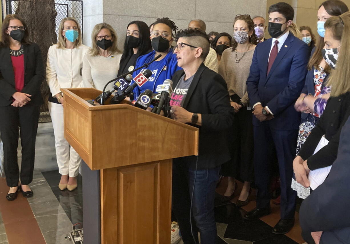 FILE - Gretchen Raffa, vice president of public policy, advocacy and organizing at Planned Parenthood of Southern New England, Inc., appears with a group of Connecticut elected officials as she speaks at a news conference, Tuesday, May 3, 2022, at the Connecticut State Capitol in Hartford. Raffa thanked lawmakers for passing legislation this session that attempts to protect providers and patients from out-of-state legal actions filed in anti-abortion states.