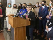 FILE - Gretchen Raffa, vice president of public policy, advocacy and organizing at Planned Parenthood of Southern New England, Inc., appears with a group of Connecticut elected officials as she speaks at a news conference, Tuesday, May 3, 2022, at the Connecticut State Capitol in Hartford. Raffa thanked lawmakers for passing legislation this session that attempts to protect providers and patients from out-of-state legal actions filed in anti-abortion states.