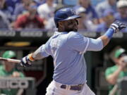 Kansas City Royals' Carlos Santana hits a two-run single during the sixth inning of a baseball game against the Oakland Athletics Sunday, June 26, 2022, in Kansas City, Mo.