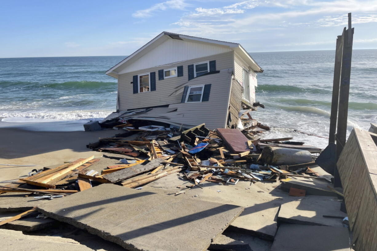 FILE - This image released by the National Park Service, shows a collapsed beachfront home along Ocean Drive in Rodanthe, N.C., on Wednesday, Feb. 9, 2022. The National Park Service issued a warning to visitors on Wednesday for debris.