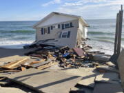 FILE - This image released by the National Park Service, shows a collapsed beachfront home along Ocean Drive in Rodanthe, N.C., on Wednesday, Feb. 9, 2022. The National Park Service issued a warning to visitors on Wednesday for debris.