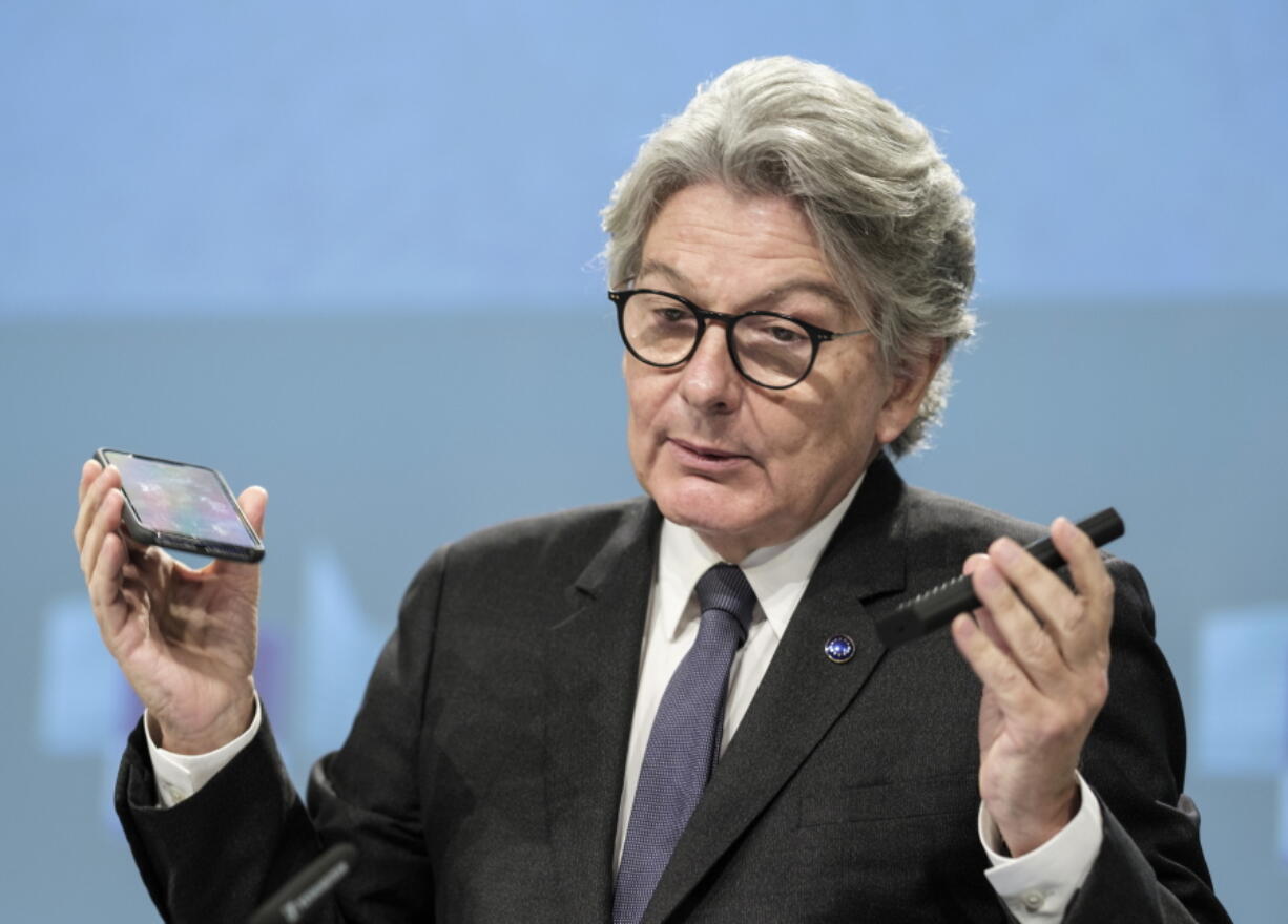 FILE - European Commissioner for Internal Market Thierry Breton speaks during a media conference on a common charging solution for mobile phones at EU headquarters in Brussels, Thursday, Sept. 23, 2021. European Union officials agreed Tuesday, June 7, 2022 on new rules requiring a uniform charging cord for smartphones and other devices, a move that would make life easier for consumers fed up with rummaging through a tangle of cables for the right one.