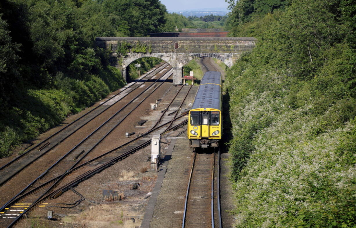 A train pulls into Hunts Cross Station, in Liverpool, England, Monday, June 20, 2022. Unions and train companies in Britain are set to hold last-minute talks Monday amid fading hopes of averting the country's biggest rail strikes for decades.