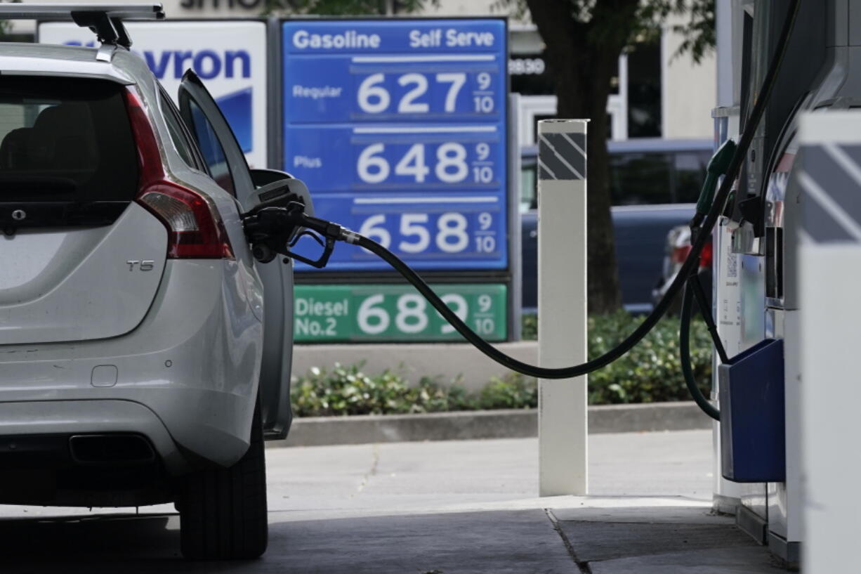 FILE-- Gas is advertised for more than $6 per gallon at a gas station in Sacramento, Calif., Friday, May 27, 2022. Many California households could soon get help to pay for the state's record-high gas prices. Most California households would get up to $1,050 from the government to help them put the nation's most expensive gasoline in their cars, part of a relief package in the state's record-setting operating budget that lawmakers are scheduled to approve later this week.