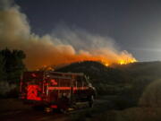 A fire engine is seen as the Sheep fire burns in Wrightwood, Calif., Monday, June 13, 2022. (AP Photo/Ringo H.W.