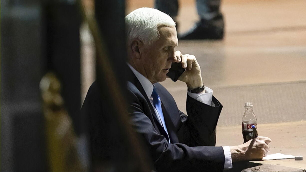 In this image from video released by the House Select Committee, Vice President Mike Pence talks on a phone from his secure evacuation location on Jan. 6 that is displayed as House select committee investigating the Jan. 6 attack on the U.S. Capitol holds a hearing Thursday, June 16, 2022, on Capitol Hill in Washington.