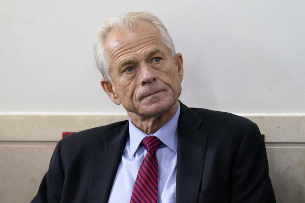 FILE - White House trade adviser Peter Navarro listens as President Donald Trump speaks during a news conference at the White House, on Aug. 14, 2020, in Washington. Former White House official Navarro was indicted Friday, June 3, 2022, on contempt charges after defying a subpoena from the House panel investigating the January 6 attack on the U.S. Capitol.