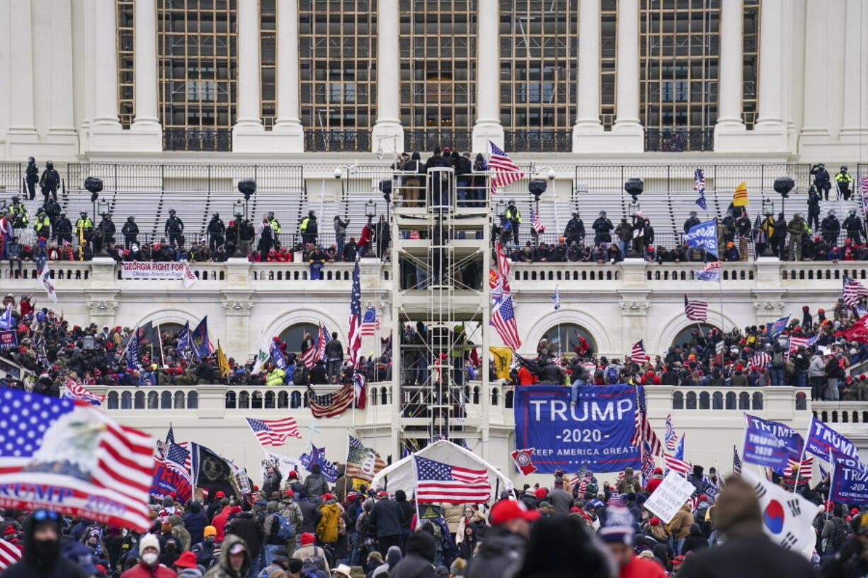 FILE - Insurrectionists loyal to President Donald Trump breach the Capitol in Washington, Jan. 6, 2021. Hatchet Speed, a U.S. Naval reservist who was assigned to an agency that operates spy satellites told an undercover FBI agent that he stormed the U.S. Capitol with members of the far-right Proud Boys extremist group, according to court records unsealed on Thursday, June 23, 2022. Speed was arrested on Wednesday in McLean, Virginia, on misdemeanor charges stemming from the Jan. 6, 2021, insurrection, including disorderly conduct in a Capitol building, court records show.