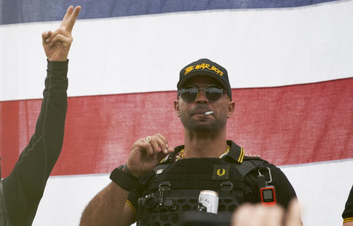 FILE - Proud Boys leader Enrique Tarrio wears a hat that says The War Boys and smokes a cigarette at a rally in Delta Park on Sept. 26, 2020, in Portland, Ore. Tarrio, the former top leader of the far-right Proud Boys extremist group, and other members were indicted Monday, June 6, 2022, on seditious conspiracy charges for what federal prosecutors say was a coordinated attack on the U.S.