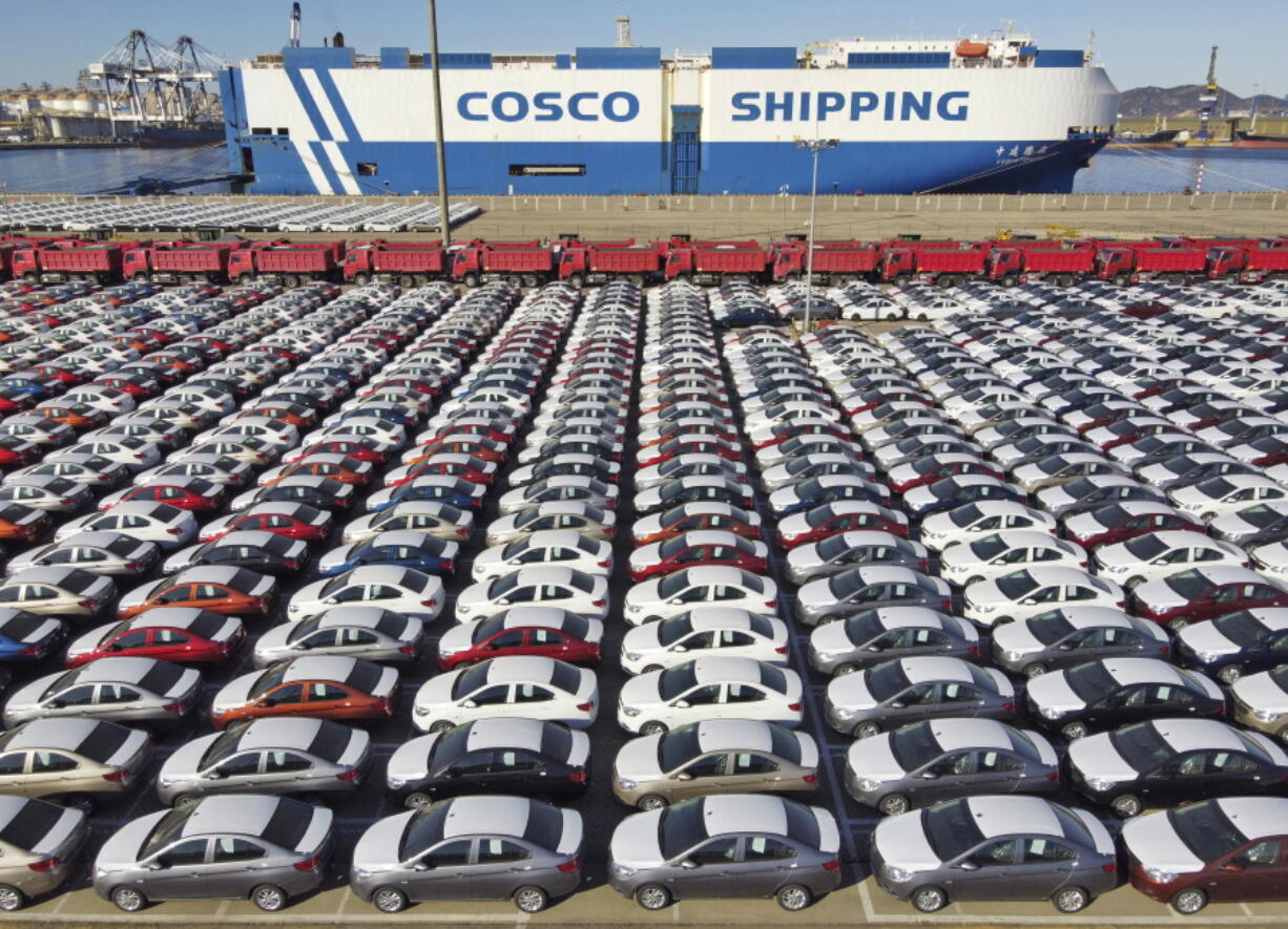 In this photo released by Xinhua News Agency, an aerial view shows manufactured vehicles before being loaded onto a cargo ship at the Yantai Port in eastern China's Shandong Province, Dec. 7, 2021. China's trade growth rebounded in May 2022 after anti-virus restrictions that shut down Shanghai and other industrial centers began to ease.