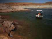 A Utah State University research team pulls in a gillnet net at Lake Powell on Tuesday, June 7, 2022, in Page, Ariz. They are on a mission to save the humpback chub, an ancient fish under assault from nonnative predators in the Colorado River.