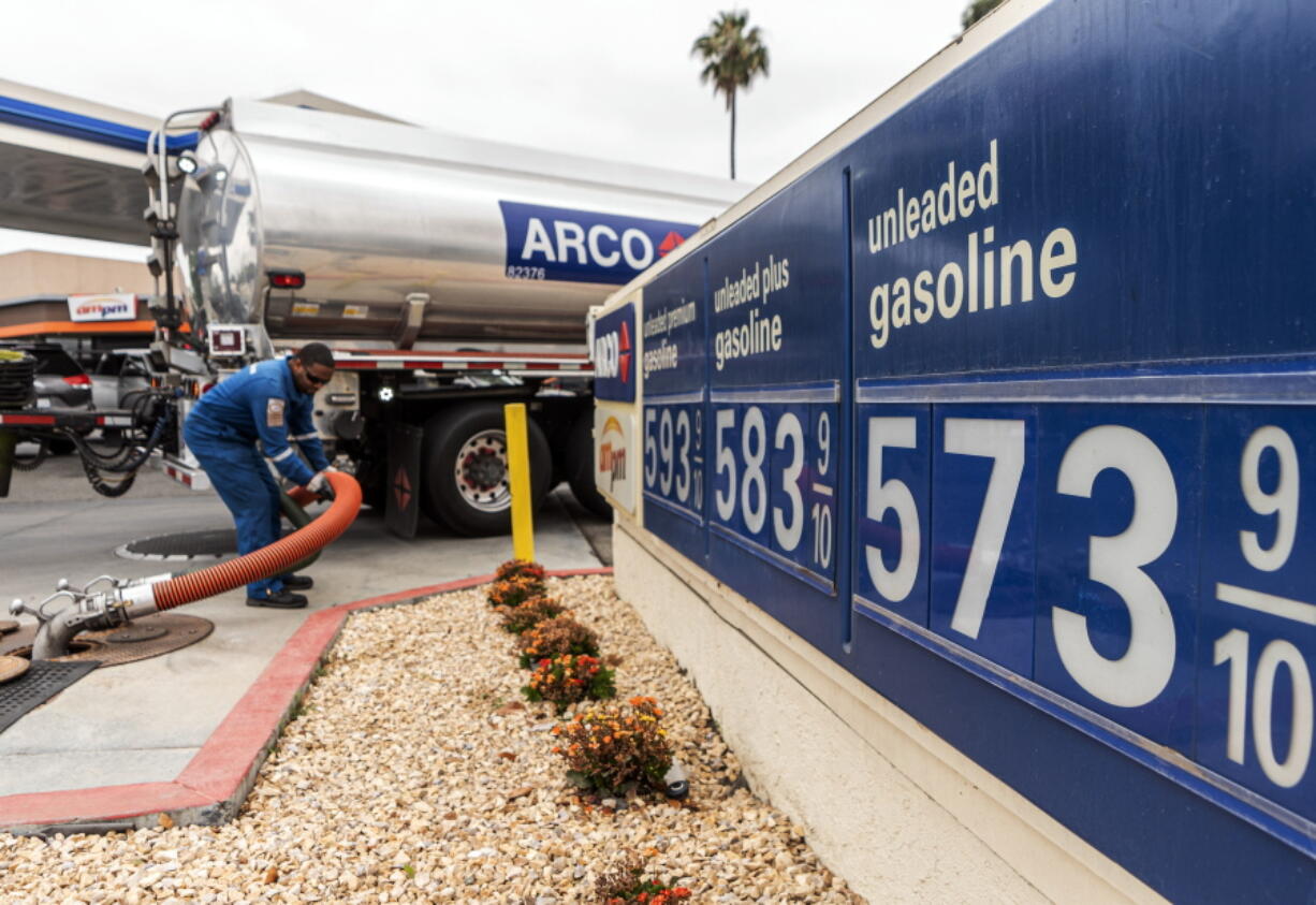 A tanker truck driver delivers 8,500 gallons of gasoline at an ARCO gas station Saturday in Riverside, Calif.