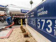 A tanker truck driver delivers 8,500 gallons of gasoline at an ARCO gas station Saturday in Riverside, Calif.