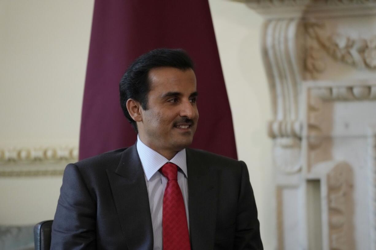 FILE - The Amir of Qatar Sheikh Tamim bin Hamad Al Thani listens to British Prime Minister Boris Johnson at the start of their meeting inside 10 Downing Street, in London, Tuesday, May 24, 2022. Qatar's emir arrived in Cairo late Friday, June 24,  to hold talks with Egypt's president in his first visit since the two countries agreed to reset relations after more than seven years of diplomatic animosity.